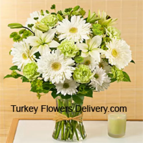 Weiße Gerberas, weiße Alstroemeria und andere verschiedene saisonale Blumen, wunderschön in einer Glasvase arrangiert