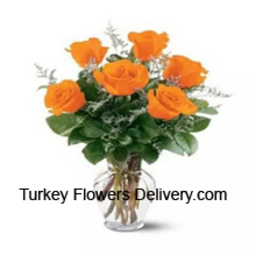 6 Yellow Roses With Some Ferns In A Glass Vase