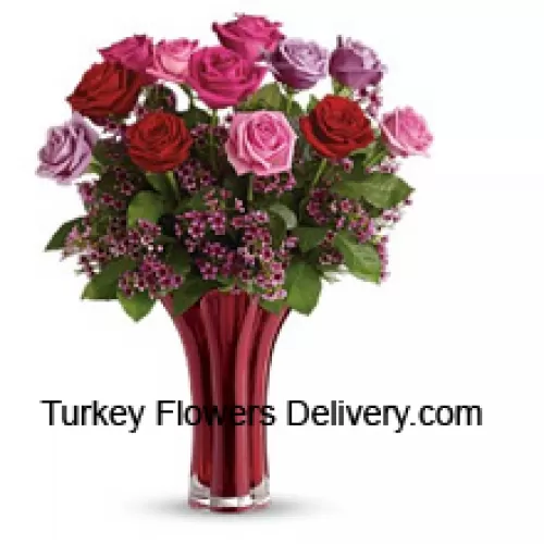 12 verschiedenfarbige Rosen mit einigen Farnen in einer Vase